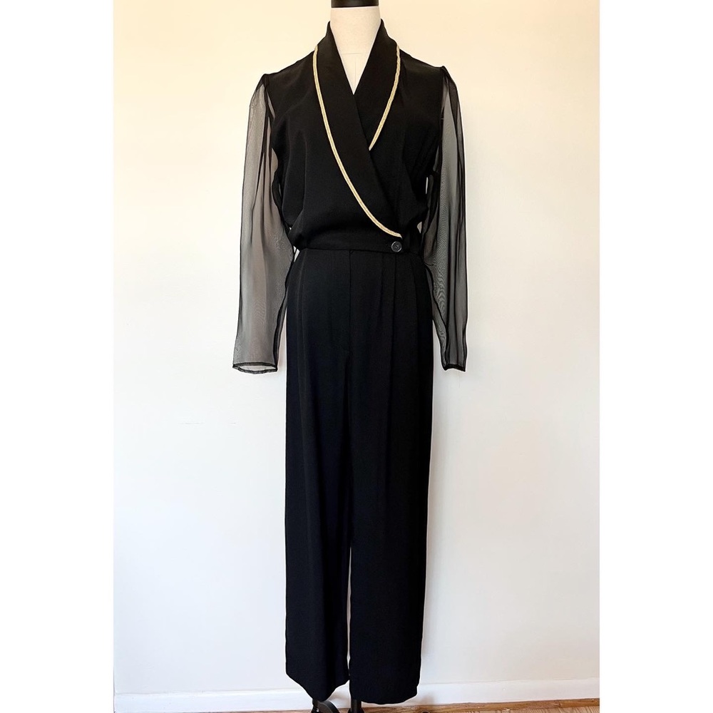 Bossy pantsuit with sheer sleeves and gold trim.